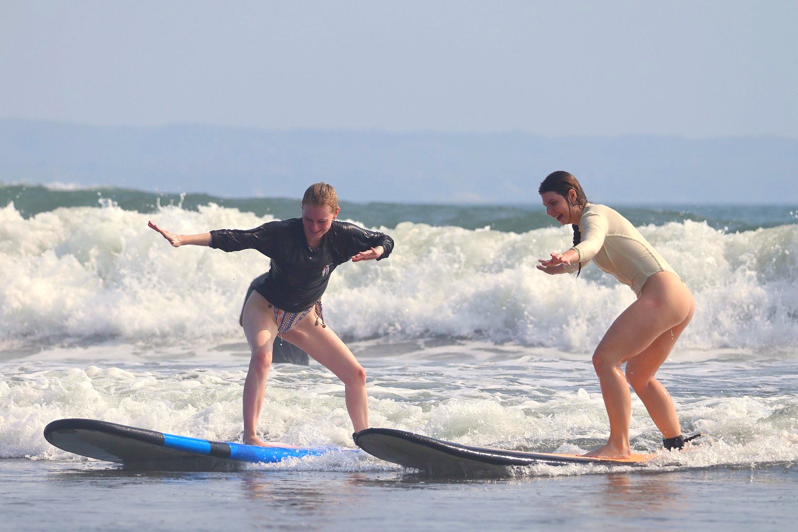Two students riding whitewater side by side