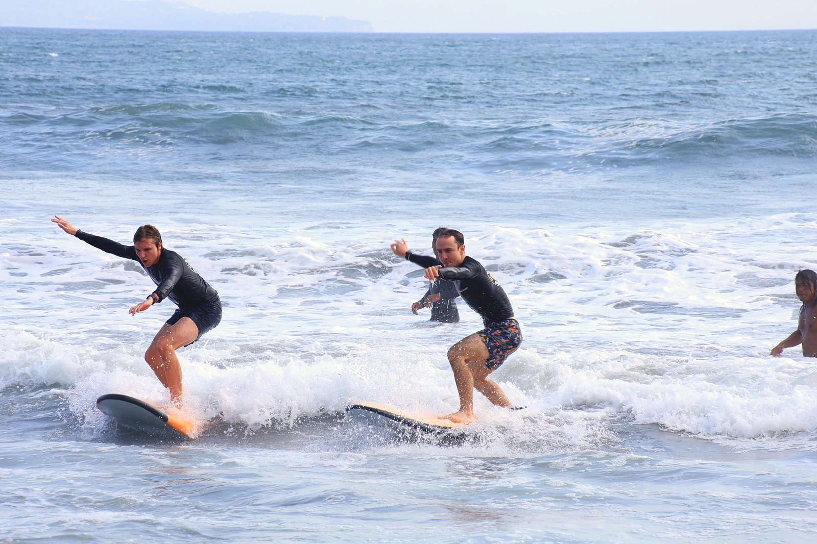 Two surfers riding whitewater together