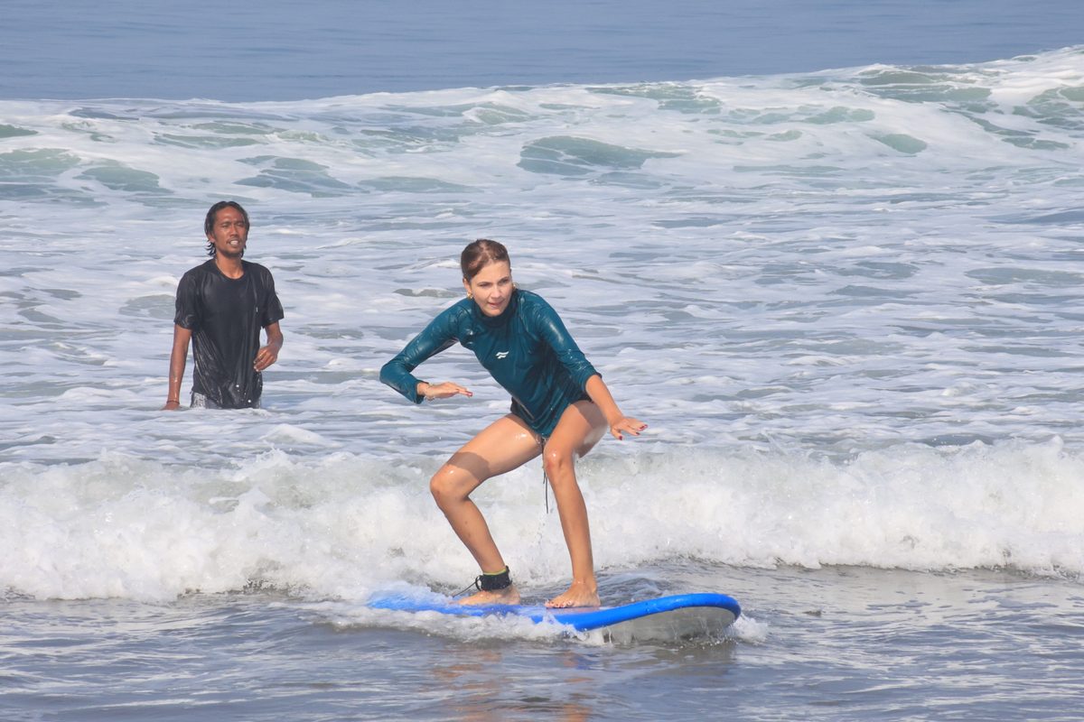 Mika watching a student ride her first wave in the whitewater