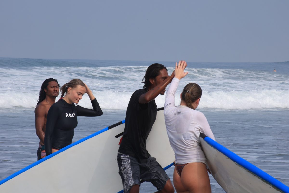 Mika high-fiving a student after a session
