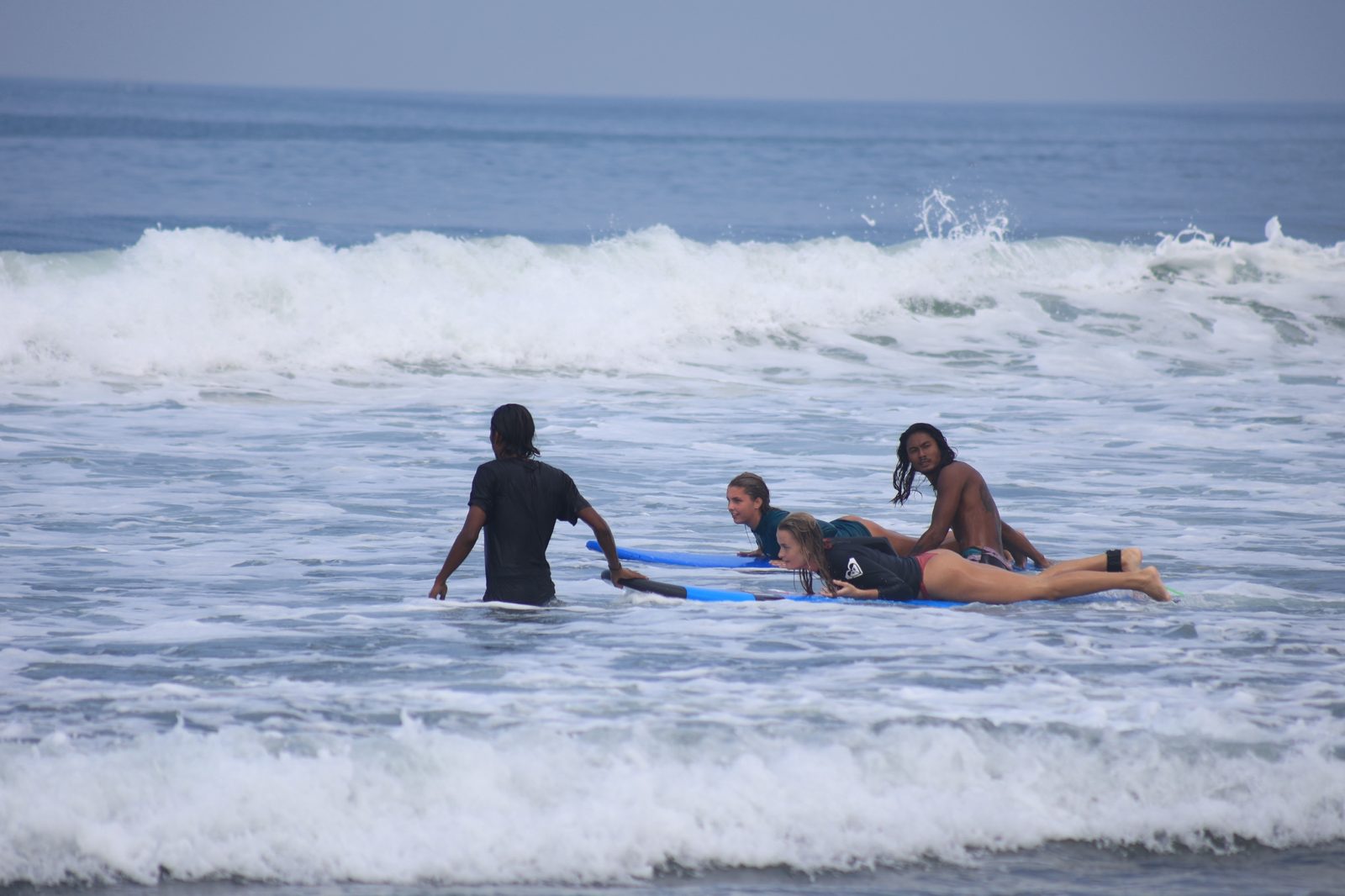 Mika and another instructor helping students paddle out through the whitewater